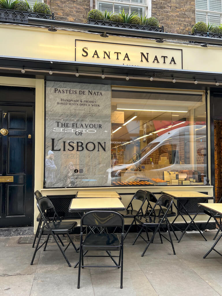 Exterior of Covent Garden cafe called Santa Nata with yellow and black store front. Copyright@2024mapandfamily.com 