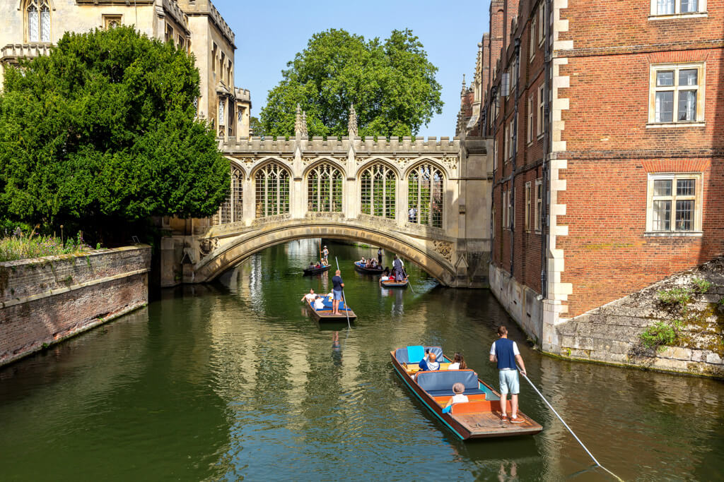 Punts on the River Cam at Cambridge, passing under the pretty gothic style covered Bridge of Sighs. 