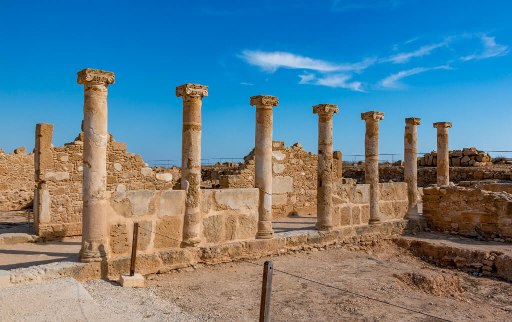 A line of Roman columns against a blue sky in Paphos, Cyprus, one of the hottest places in Europe in November. 