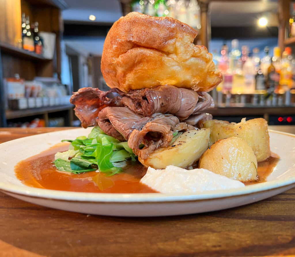 A typical London pub roast with roast beef, Yorkshire pudding, potatoes, cabbage and gravy. Copyright@2024NancyRoberts