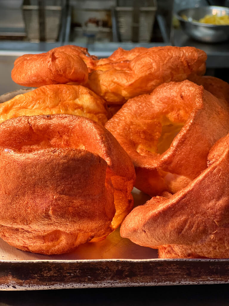 Yorkshire puddings, risen high and fluffy, ready to serve. Copyright@2024NancyRoberts