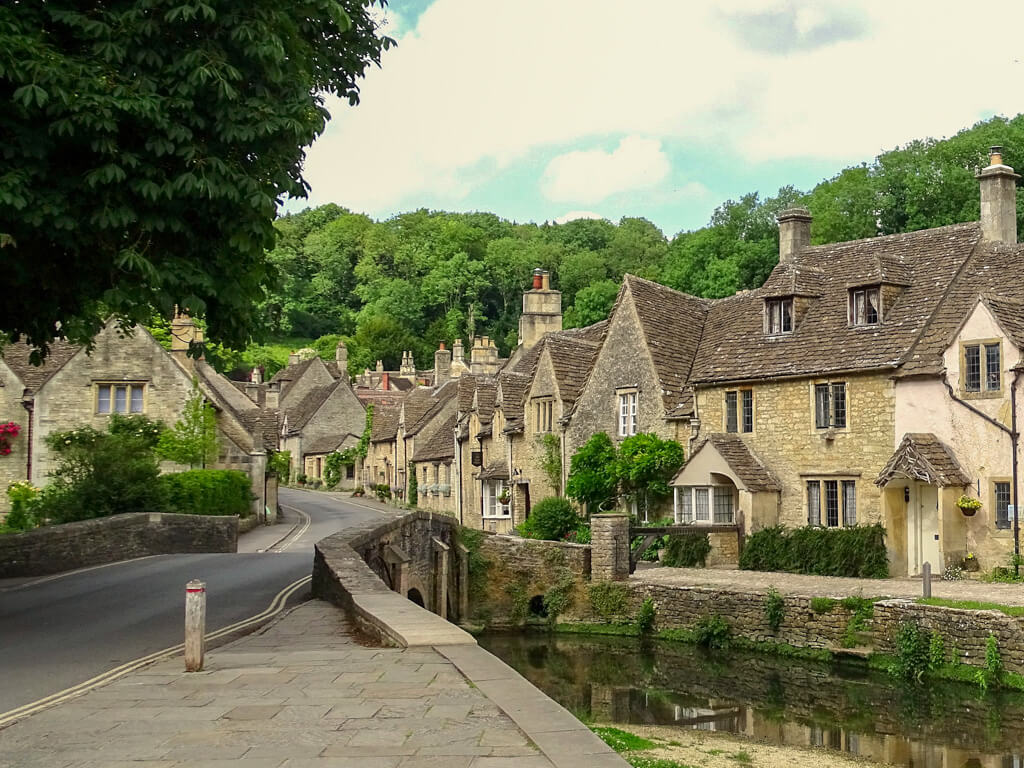 Peaceful English village scene of honey-coloured stone cottages and bridge. Copyright@2025NancyRoberts