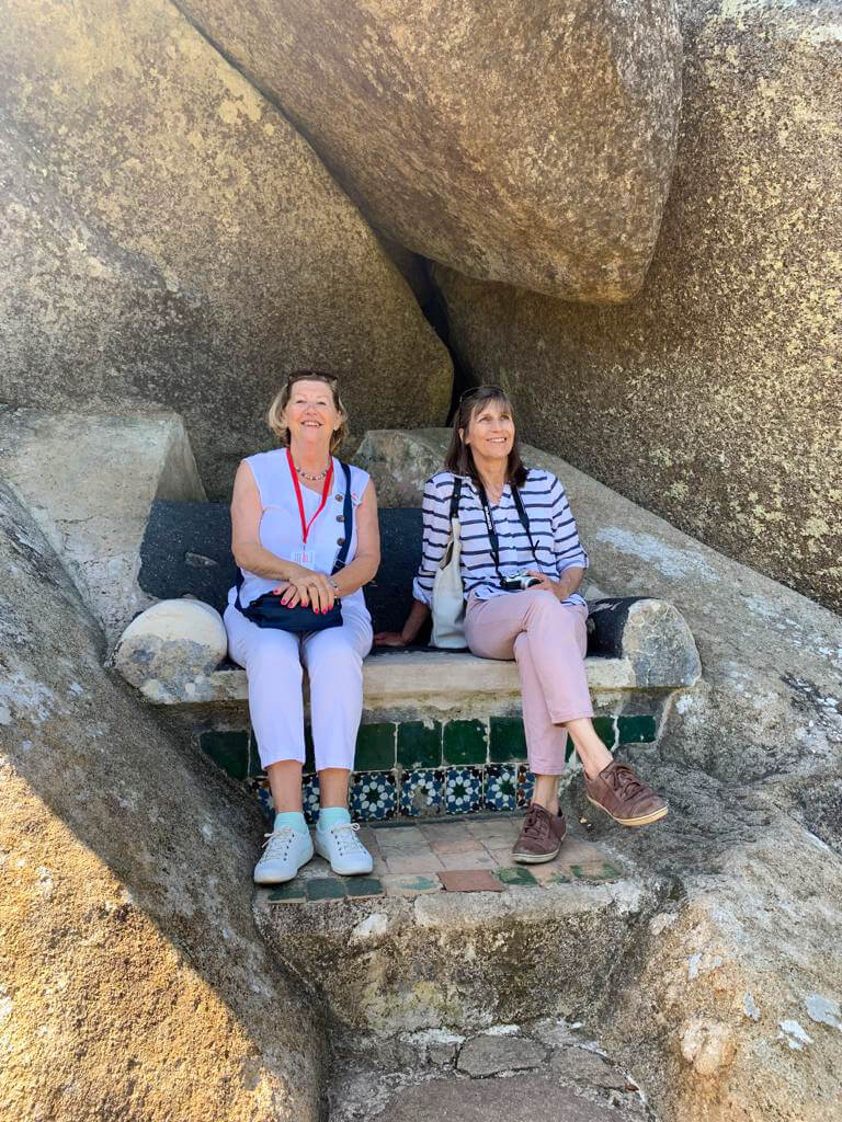 Two women, Eva and Nancy, sitting on bench in Pena Park. Copyright@2025 NancyRoberts