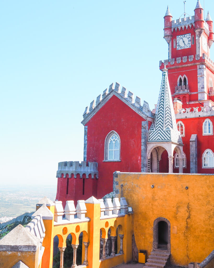 Brightly coloured red clock tower at Pena  Palace. Copyright@2025 NancyRoberts