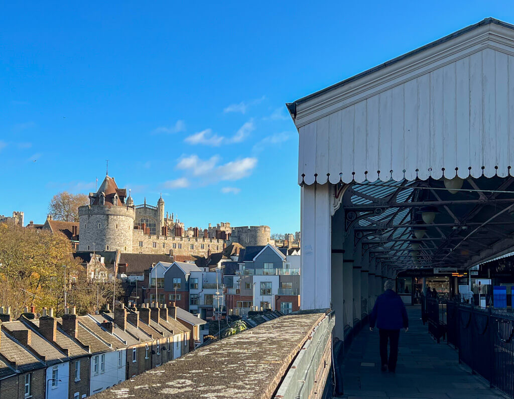 View of Windsor castle against blue sky from the train station platform on a day trip from London by train. Copyright@2025 NancyRoberts