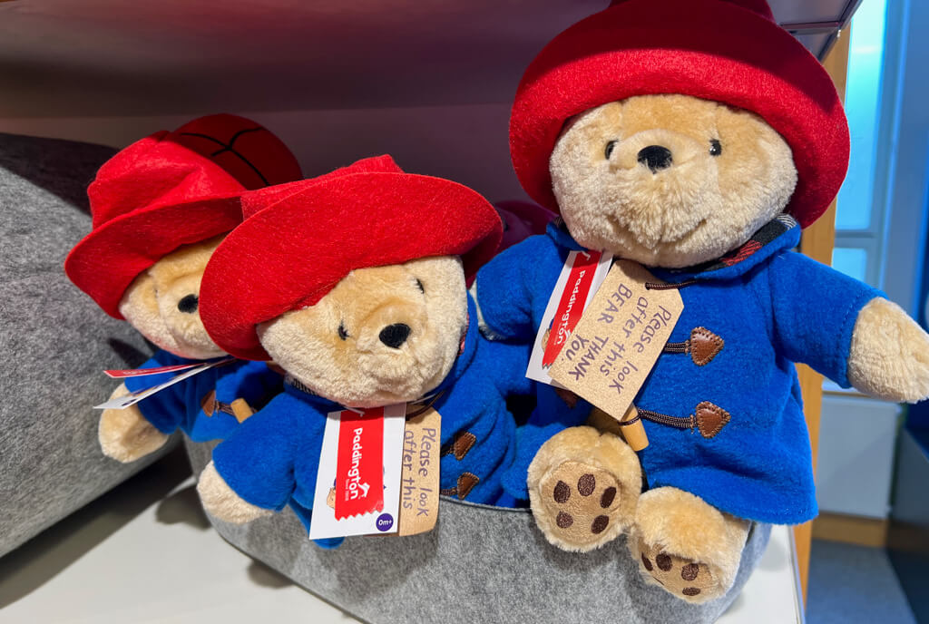 British souvenirs london: 3 soft toys of Paddington bear with red hats and blue duffle coats. Copyright@2025 NancyRoberts