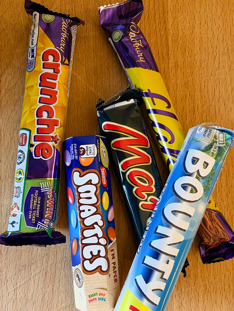 Cheap London souveniers - five confectionery bars in colourful wrappers including Crunchie and Mars. Copyright@2025 NancyRoberts