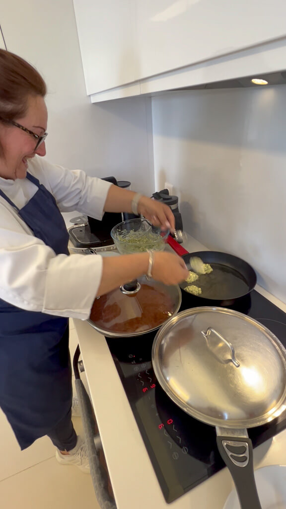 Private chef Virginia cooking on hob in kitchen of Villa Bliss. Copyright@2025 NancyRoberts
