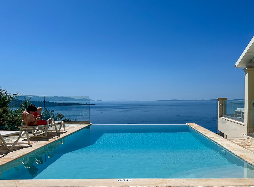 View of the sea at Kalami bay from the infinity pool of Villa Bliss on the hillside above the bay. Copyright@2025 NancyRoberts
