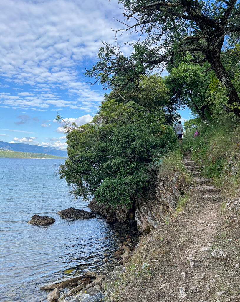 Uneven stone steps on a natural coastal path near Kalami. Copyright@2025 NancyRoberts