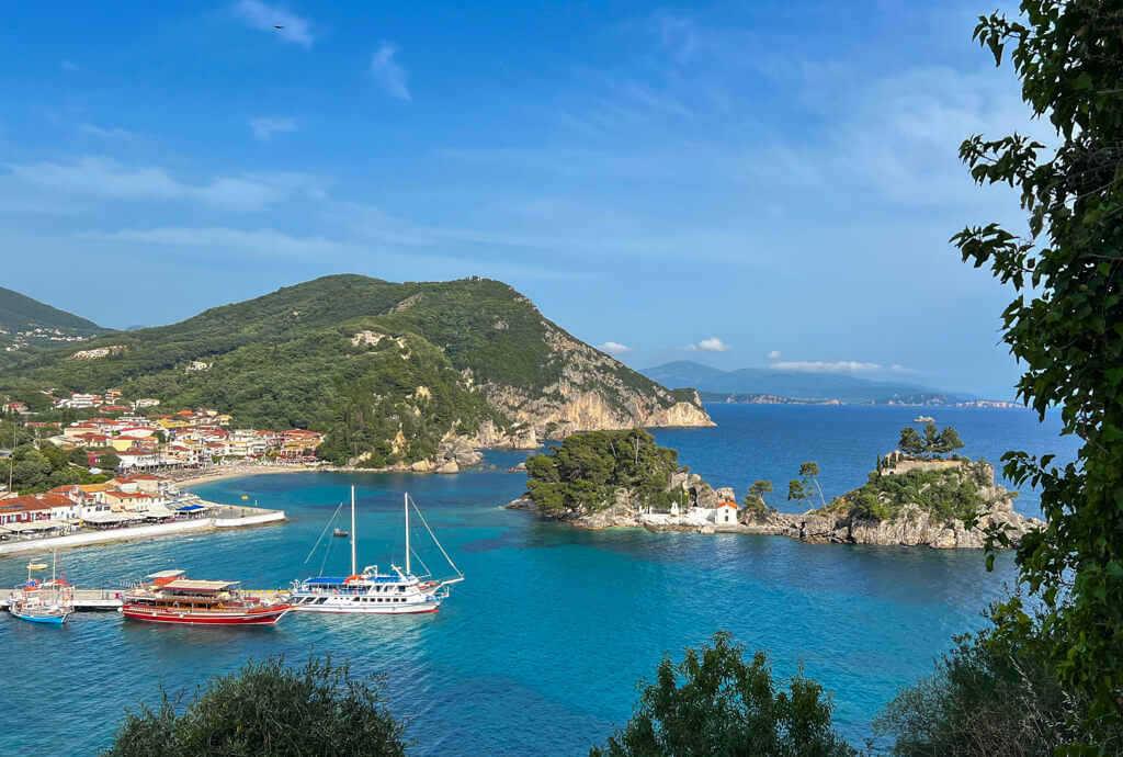 The islet of Panagia in the harbour of Parga with boats nearby. Copyright@2025 NancyRoberts