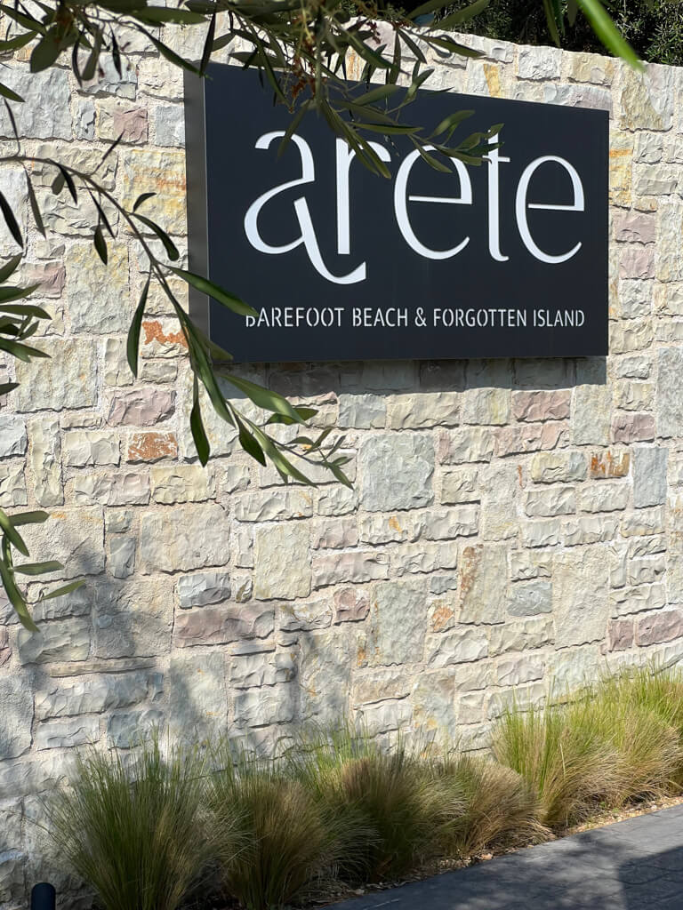 Arete hotel sign with olive branches in foreground. Copyright@2025 NancyRoberts