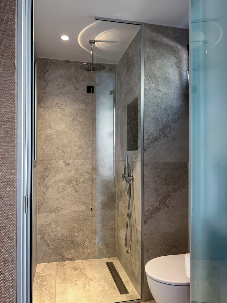 Grey tiled shower room. Copyright@2025 NancyRoberts