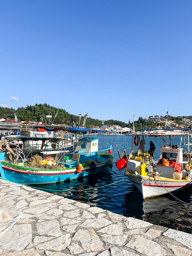 Colourful painted wooden boats moored at the quay in Sivota Greece. Copyright@2025 NancyRoberts