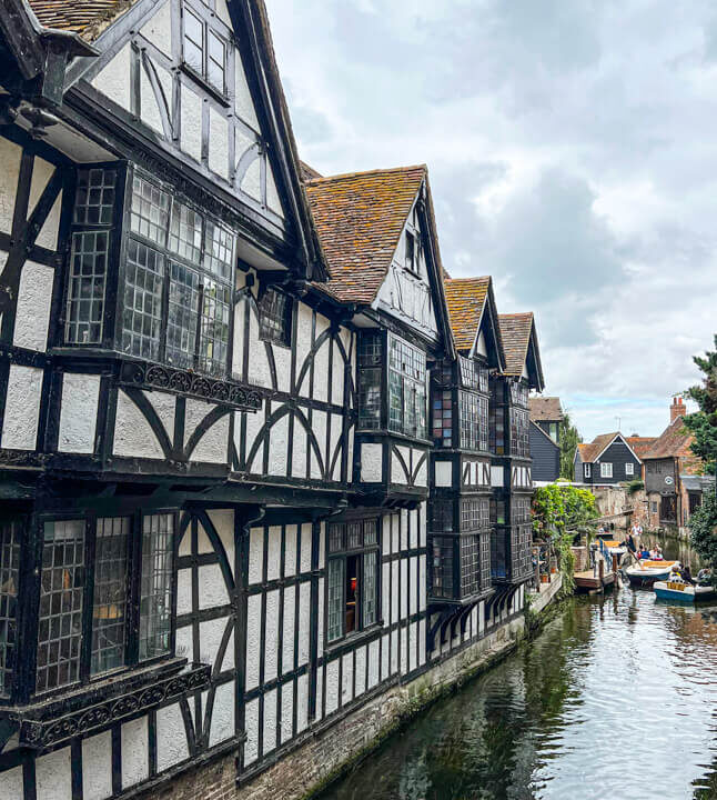 Black and white medieval building by river in Canterbury. Copyright@2025 Nancy Roberts