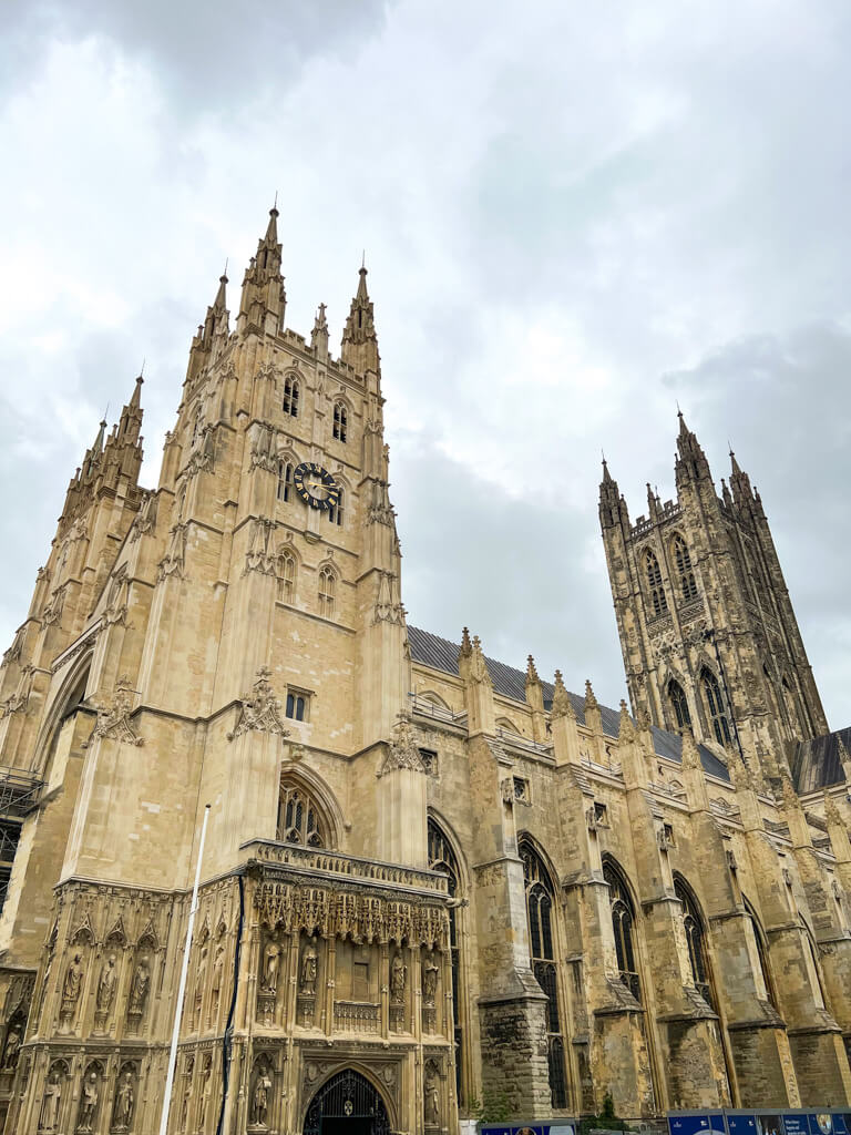 The magnificent stone Gothic towers of Canterbury Cathedral against a cloudy sky. Copyright@2025 Nancy Roberts